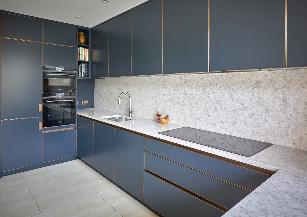 Photo of a mid-sized industrial l-shaped eat-in kitchen in London with a double-bowl sink, flat-panel cabinets, blue cabinets, quartzite benchtops, multi-coloured splashback, marble splashback, black appliances, porcelain floors, with island, beige floor, multi-coloured benchtop and coffered.