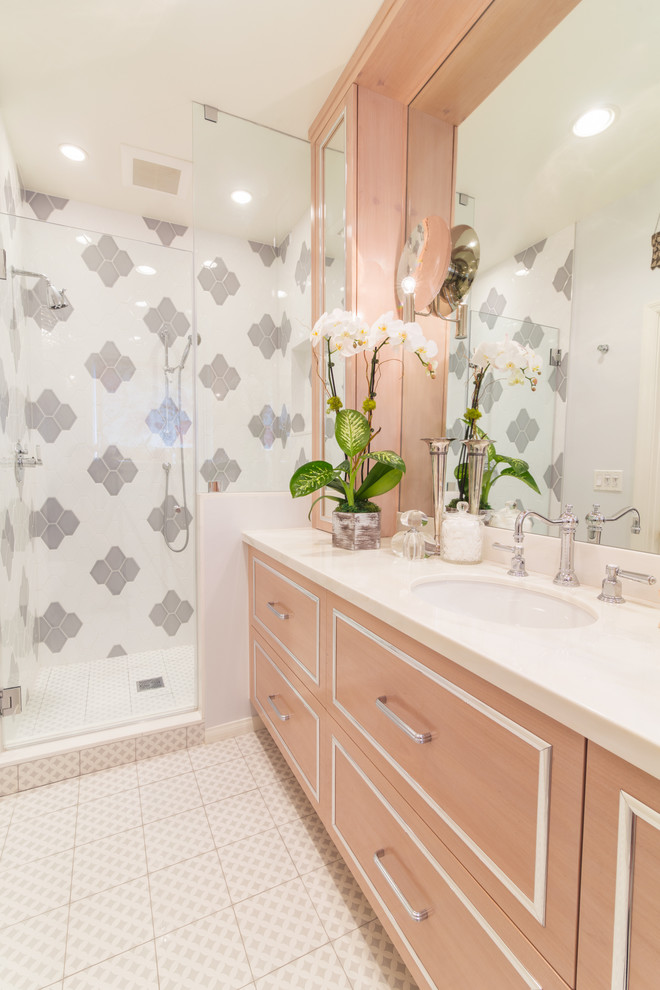 Photo of a mid-sized transitional 3/4 bathroom in Los Angeles with flat-panel cabinets, light wood cabinets, an alcove shower, a two-piece toilet, white tile, porcelain tile, grey walls, porcelain floors, an undermount sink, marble benchtops, white floor and a hinged shower door.