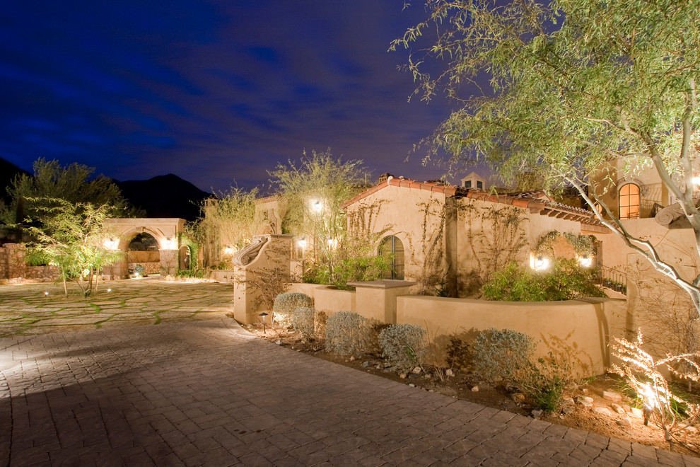 Inspiration for an expansive traditional front yard patio in Phoenix with a fire feature, natural stone pavers and a gazebo/cabana.