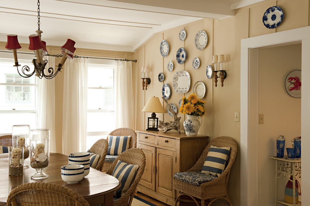 Photo of a mid-sized beach style separate dining room in New York with beige walls and medium hardwood floors.