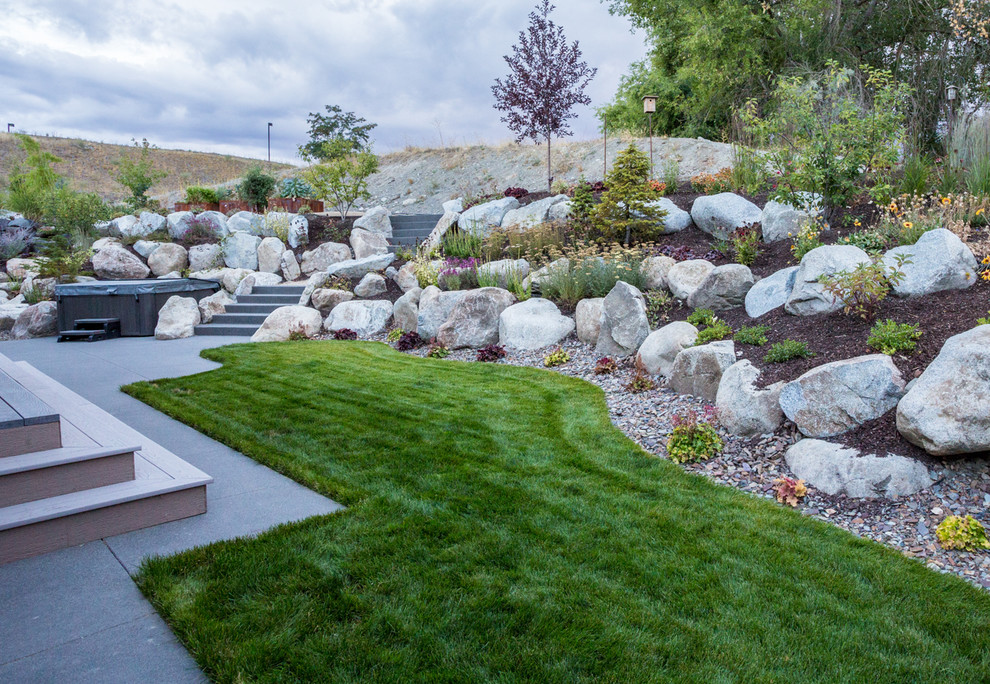 This is an example of a small transitional backyard retaining wall landscape.