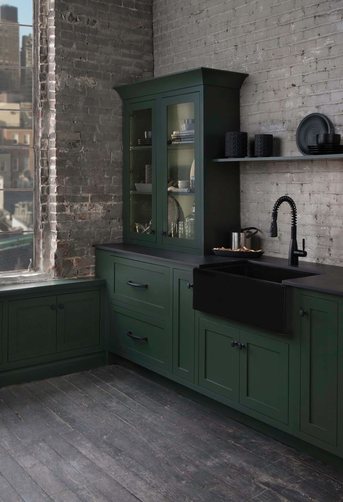 Inspiration for a small traditional galley kitchen in Raleigh with an integrated sink, green cabinets, grey splashback, brick splashback, coloured appliances, dark hardwood floors, brown floor and black benchtop.