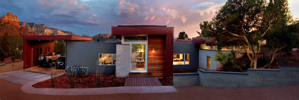 This is an example of a mid-sized contemporary two-storey concrete exterior in Phoenix.