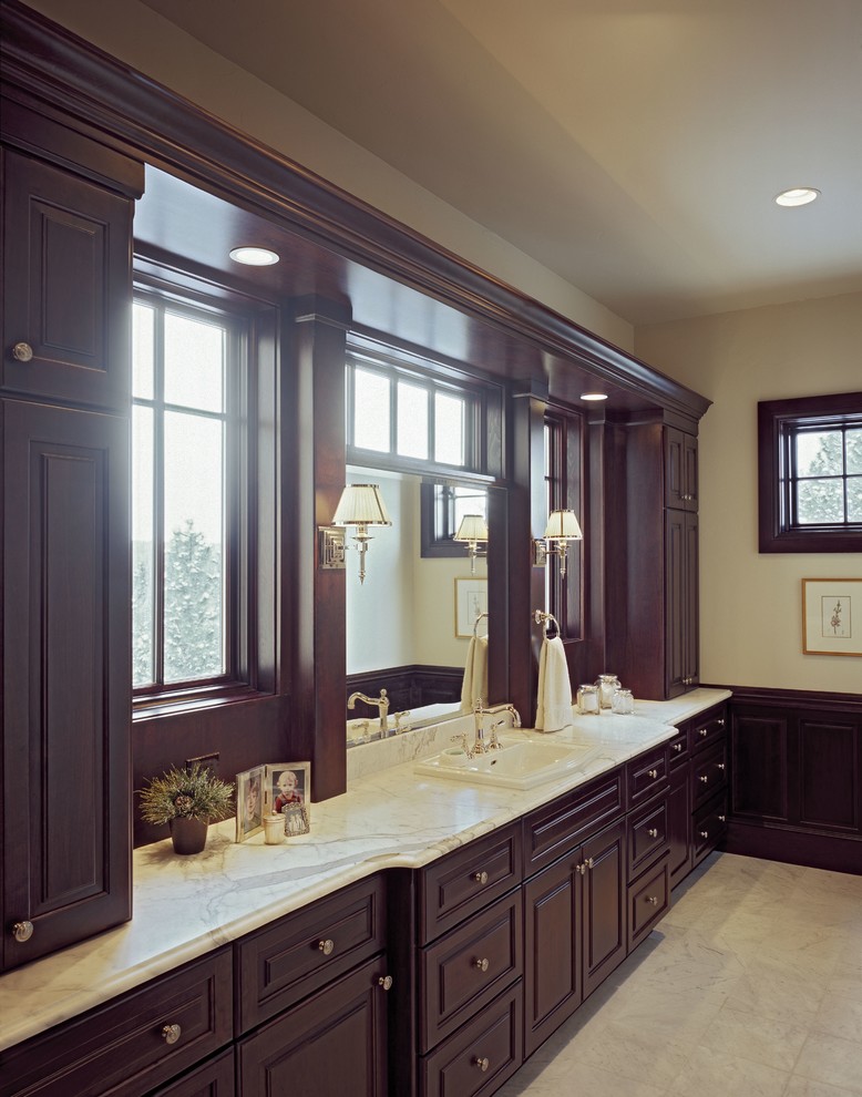 Design ideas for a large traditional master bathroom in Denver with a drop-in sink, raised-panel cabinets, dark wood cabinets, marble benchtops, white tile and white walls.