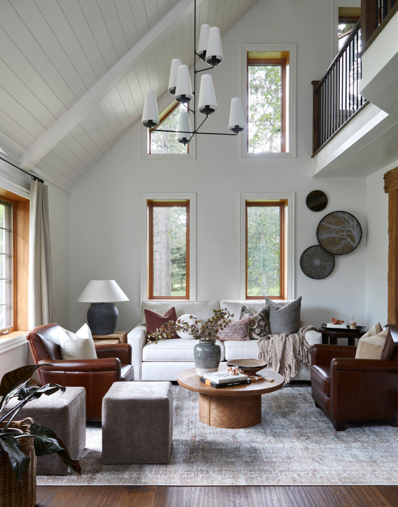 Mid-sized transitional loft-style medium tone wood floor, brown floor, vaulted ceiling and shiplap wall living room photo in Toronto with white walls