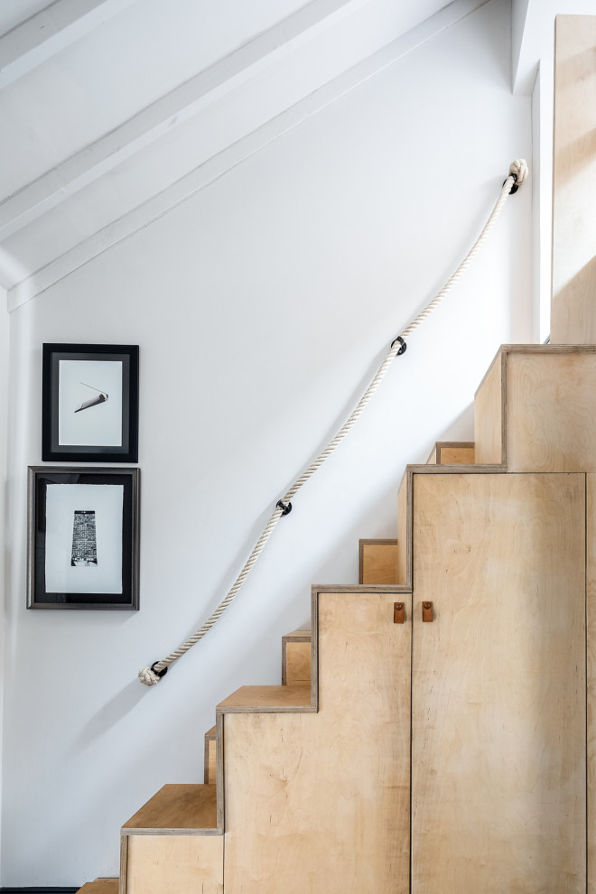 Inspiration for a small eclectic wood staircase in London with wood risers and mixed railing.