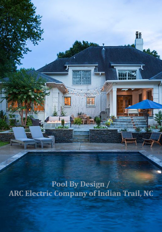 Inspiration for a large backyard rectangular pool in Charlotte with tile.