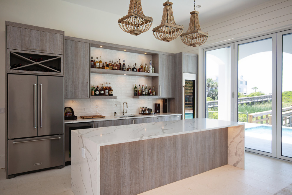 Inspiration for a large coastal single-wall wet bar in Miami with a built-in sink, flat-panel cabinets, light wood cabinets, quartz worktops, white splashback, ceramic flooring, beige floors and white worktops.