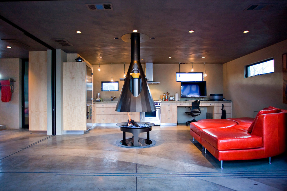 Photo of an industrial single-wall open plan kitchen in Sacramento with flat-panel cabinets, light wood cabinets and stainless steel appliances.