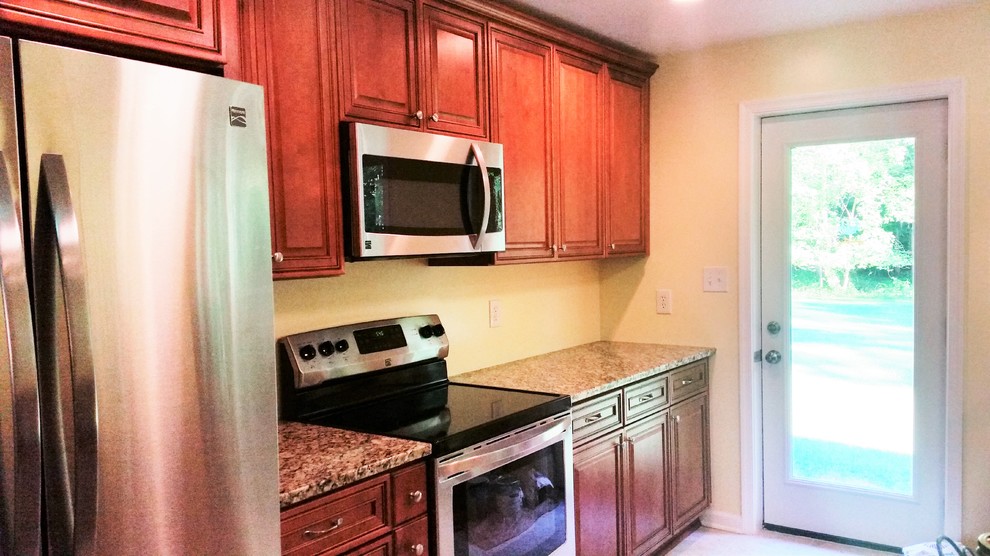 Inspiration for a mid-sized transitional u-shaped porcelain tile eat-in kitchen remodel in DC Metro with an undermount sink, medium tone wood cabinets, granite countertops, stainless steel appliances and an island