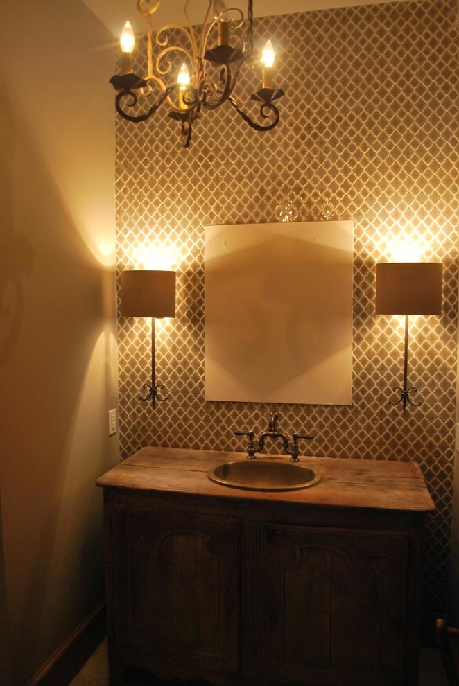 Mid-sized mediterranean powder room in Other with dark wood cabinets, wood benchtops, porcelain tile and beige walls.