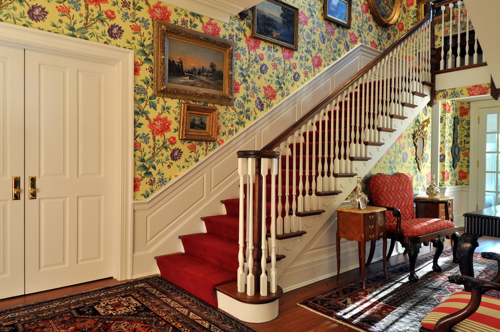 This is an example of a traditional wood straight staircase in Other with painted wood risers.