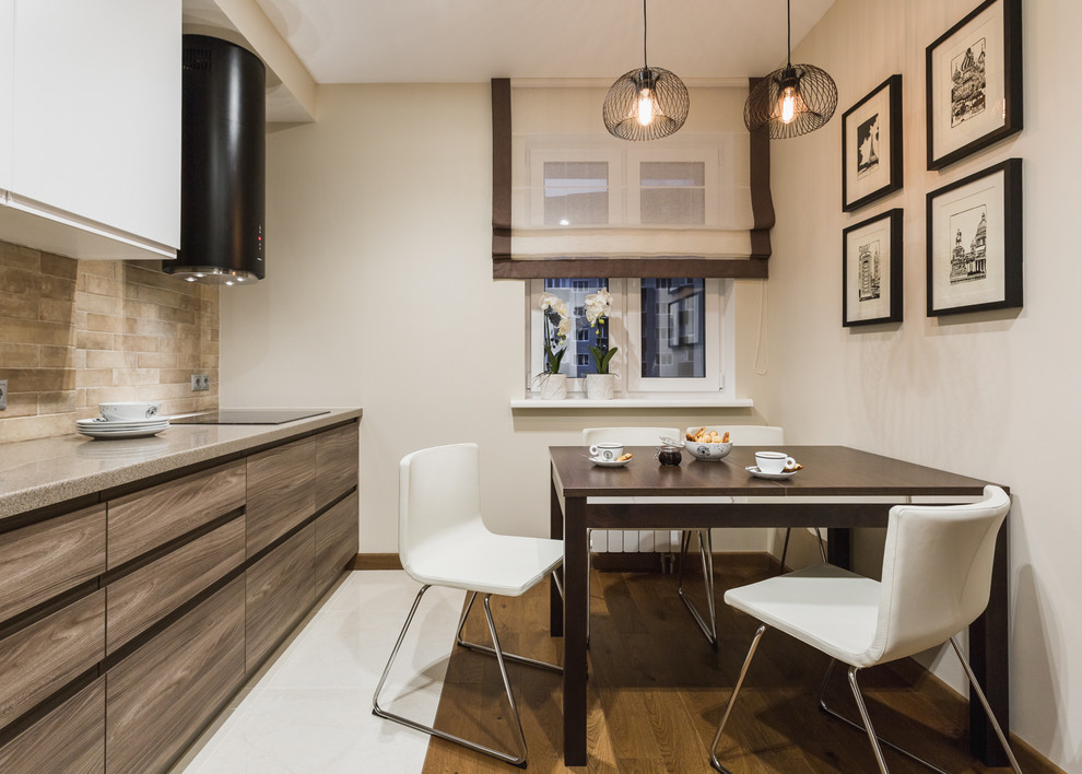 Photo of a mid-sized contemporary single-wall separate kitchen in Moscow with a drop-in sink, flat-panel cabinets, medium wood cabinets, solid surface benchtops, beige splashback, ceramic splashback, black appliances, porcelain floors and no island.