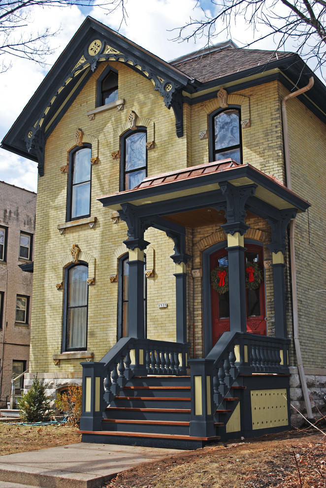 Photo of a large traditional two-storey brick yellow exterior in New York.
