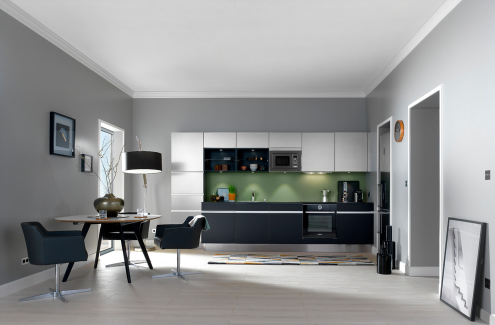 Inspiration for a mid-sized contemporary single-wall open plan kitchen in Nantes with grey cabinets, laminate benchtops, green splashback, glass sheet splashback, stainless steel appliances, no island and beaded inset cabinets.