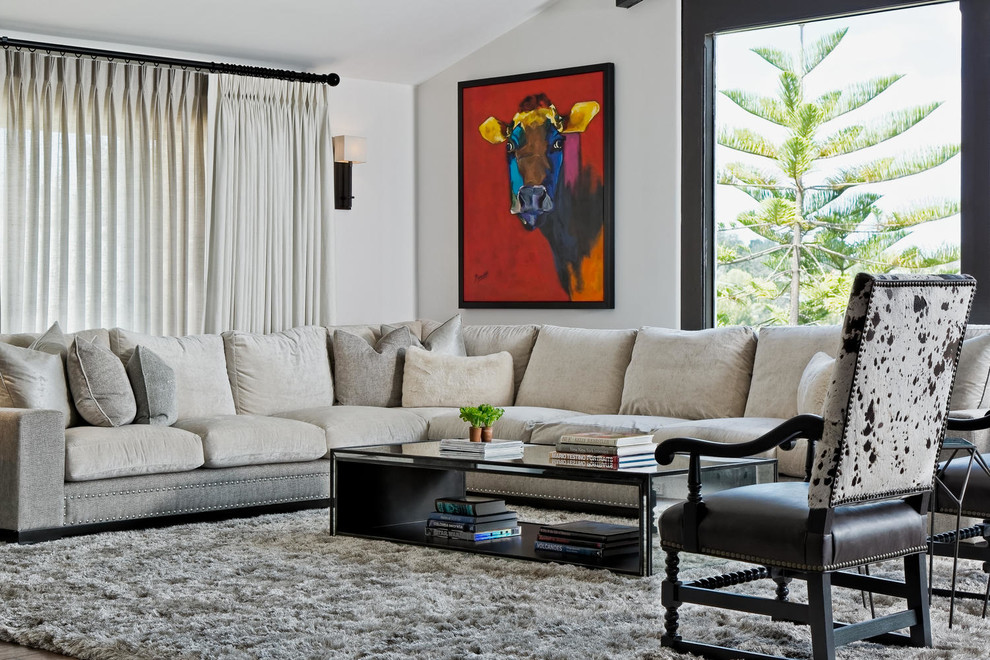 This is an example of a contemporary living room in Los Angeles with white walls and dark hardwood floors.