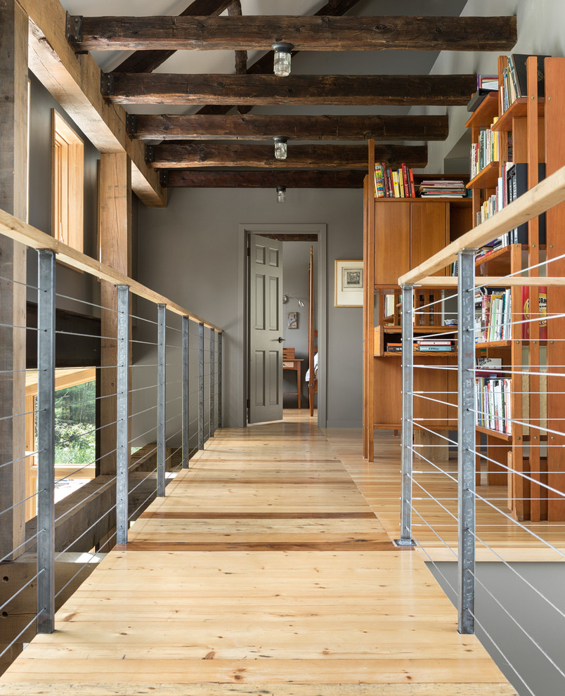 Inspiration for a transitional light wood floor hallway remodel in Portland Maine with gray walls