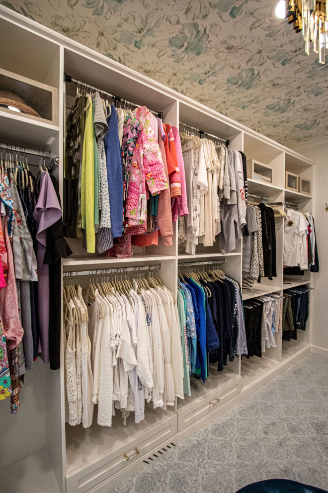 Inspiration for a mid-sized traditional women's walk-in wardrobe in Cleveland with flat-panel cabinets, white cabinets, carpet, grey floor and wallpaper.