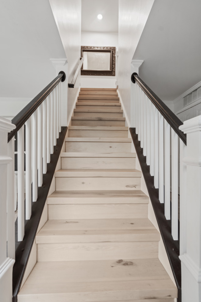 Inspiration for a mid-sized transitional wood straight staircase in DC Metro with wood risers and wood railing.