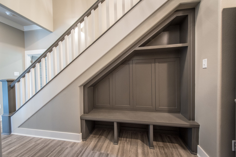 This is an example of a mid-sized arts and crafts mudroom in Little Rock with grey walls, medium hardwood floors and a single front door.