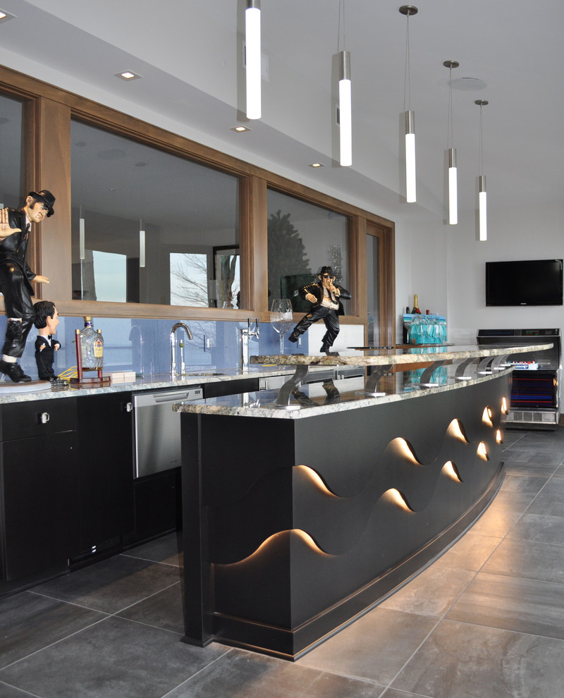 Large contemporary galley seated home bar in Cleveland with an undermount sink, flat-panel cabinets, quartzite benchtops, blue splashback, glass sheet splashback, ceramic floors, black cabinets, grey floor and multi-coloured benchtop.