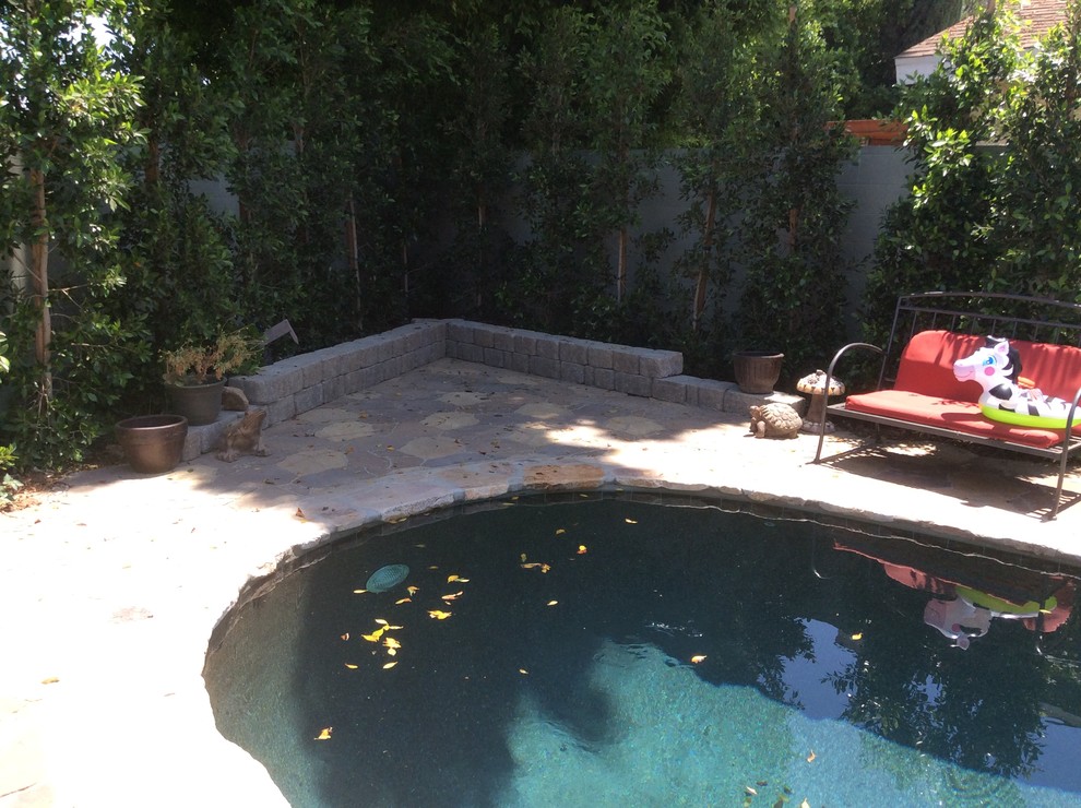 Inspiration for a large country backyard patio in Los Angeles with natural stone pavers and no cover.