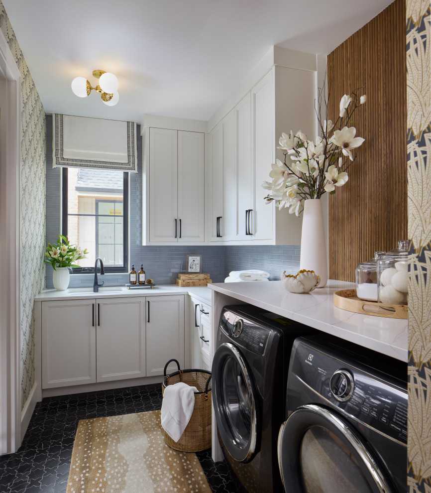 Example of a large transitional l-shaped marble floor, black floor and wallpaper dedicated laundry room design in Denver with white cabinets, quartz countertops, blue backsplash, subway tile backsplash, a side-by-side washer/dryer, white countertops, an undermount sink, recessed-panel cabinets and multicolored walls