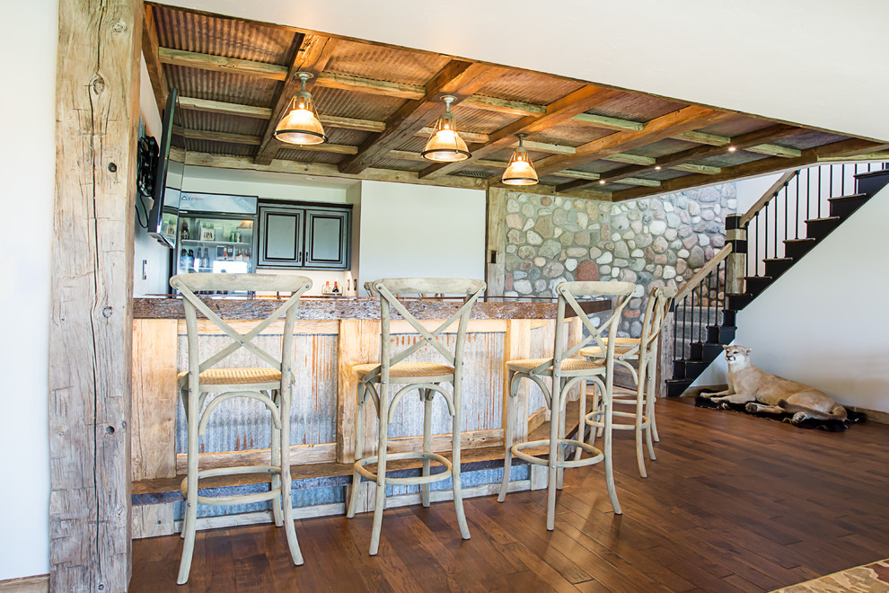 Inspiration for a large rustic walk-out dark wood floor basement remodel with white walls and a standard fireplace