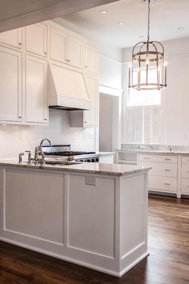 Inspiration for a mid-sized transitional u-shaped open plan kitchen in Atlanta with an undermount sink, beaded inset cabinets, white cabinets, marble benchtops, white splashback, subway tile splashback, stainless steel appliances, medium hardwood floors and a peninsula.