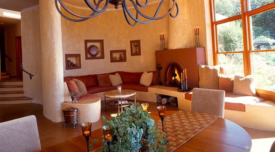 Inspiration for a mid-sized contemporary formal open concept living room in San Francisco with a standard fireplace, a plaster fireplace surround, brown floor, beige walls, concrete floors and no tv.