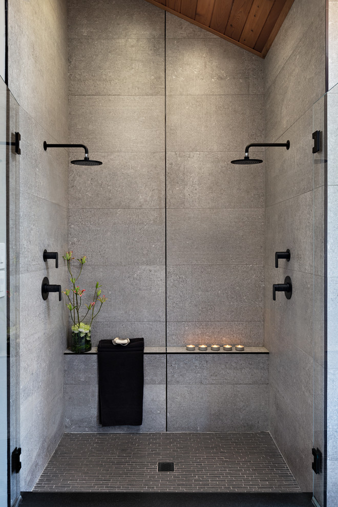 This is an example of a large modern master bathroom in Other with medium wood cabinets, a double shower, a one-piece toilet, gray tile, grey walls, a vessel sink, grey floor, a hinged shower door, black benchtops, cement tile, concrete floors and concrete benchtops.
