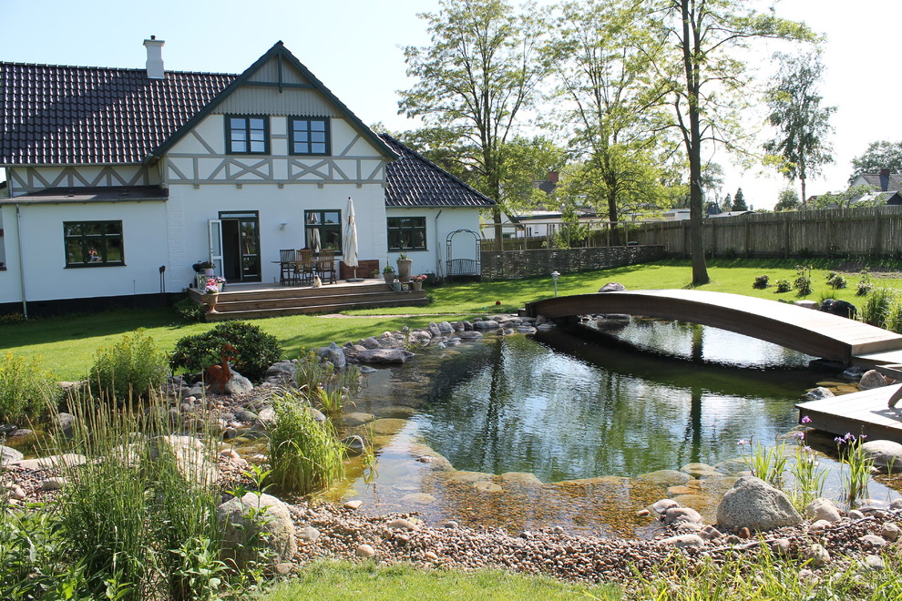 This is an example of a large scandinavian garden in Other.