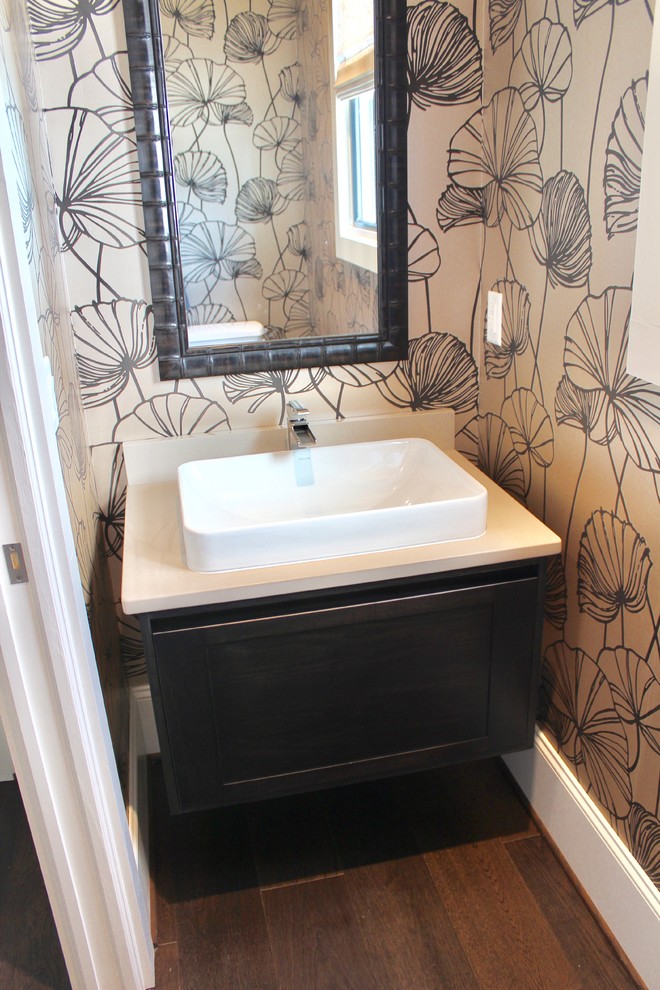 This is an example of a small modern powder room in Other with shaker cabinets, dark wood cabinets, medium hardwood floors, a vessel sink, engineered quartz benchtops and brown floor.