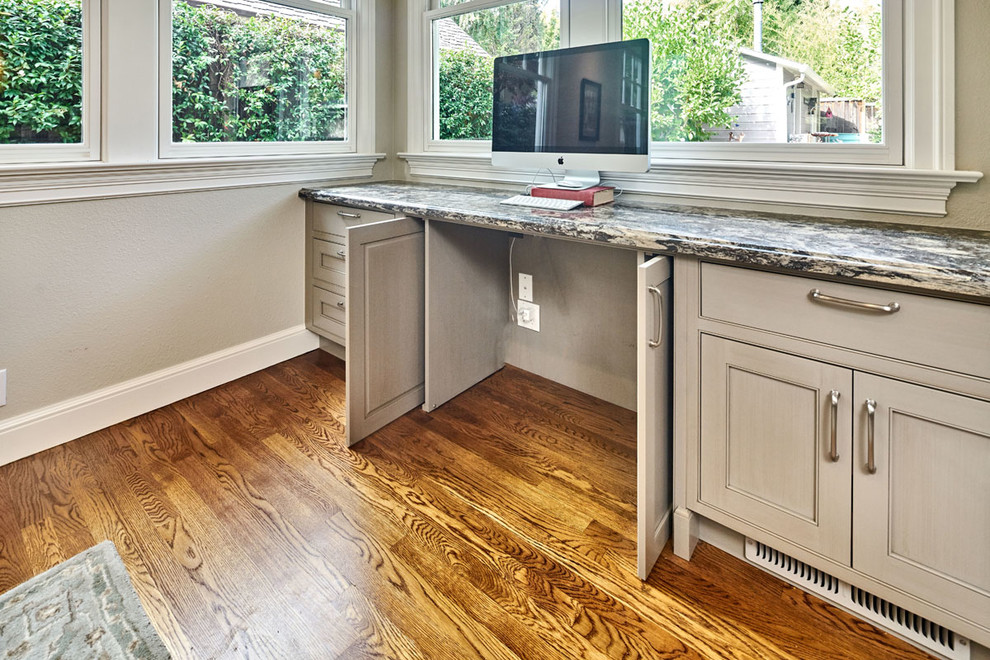 Eat-in kitchen - mid-sized transitional l-shaped medium tone wood floor eat-in kitchen idea in San Francisco with an undermount sink, beaded inset cabinets, gray cabinets, quartz countertops, gray backsplash, ceramic backsplash, paneled appliances and an island