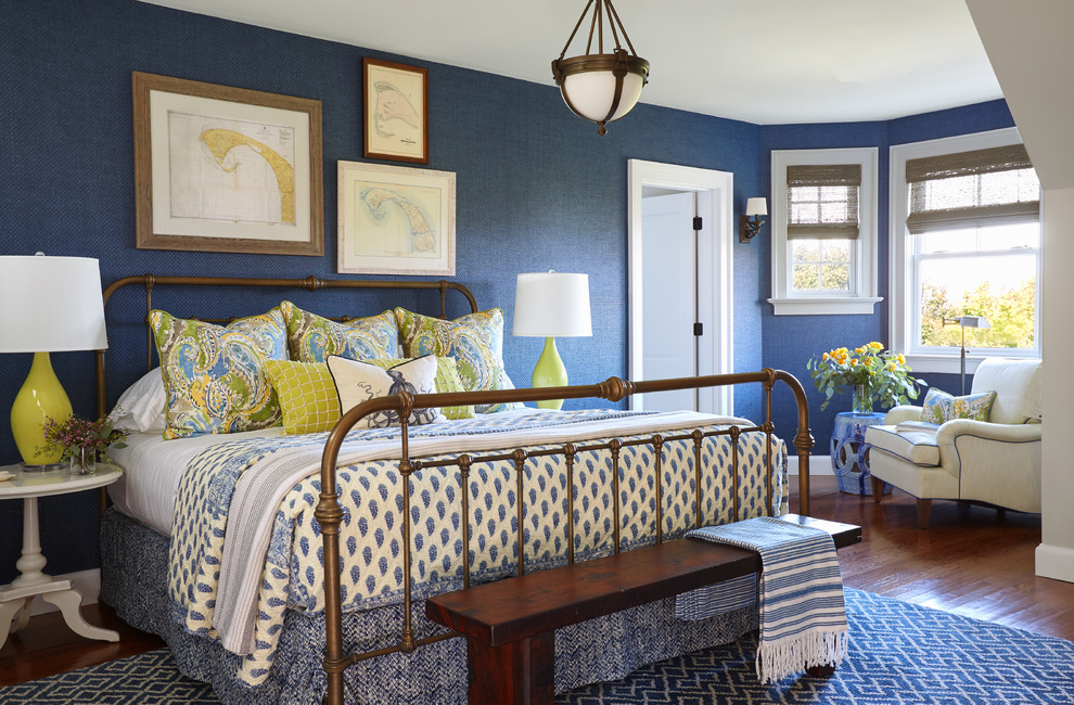 Photo of a large beach style guest bedroom in Boston with blue walls, medium hardwood floors and brown floor.