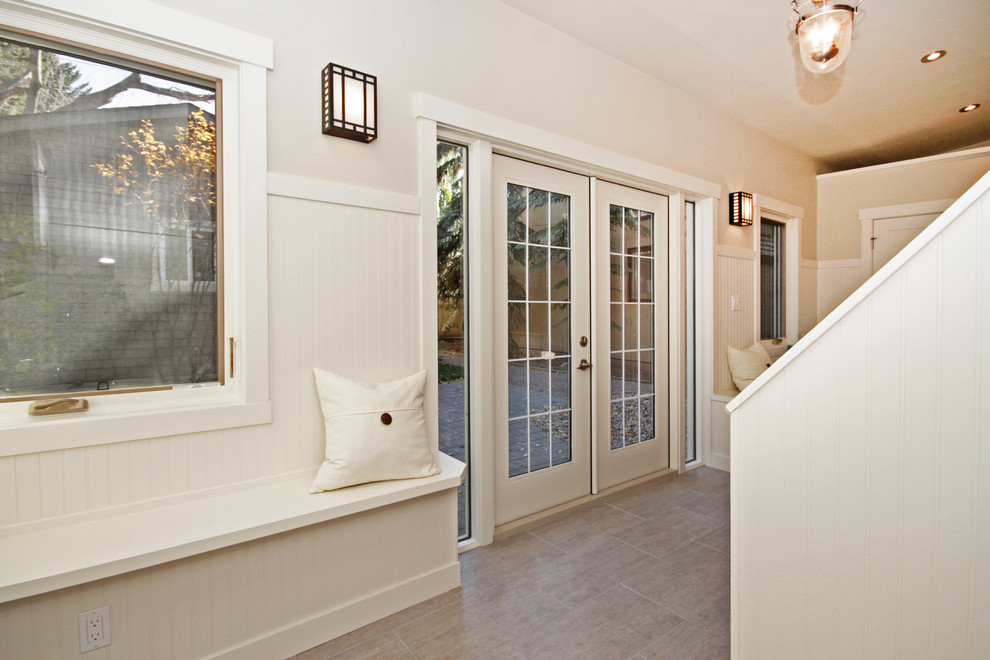 Inspiration for a mid-sized transitional carpeted hallway remodel in Calgary with white walls