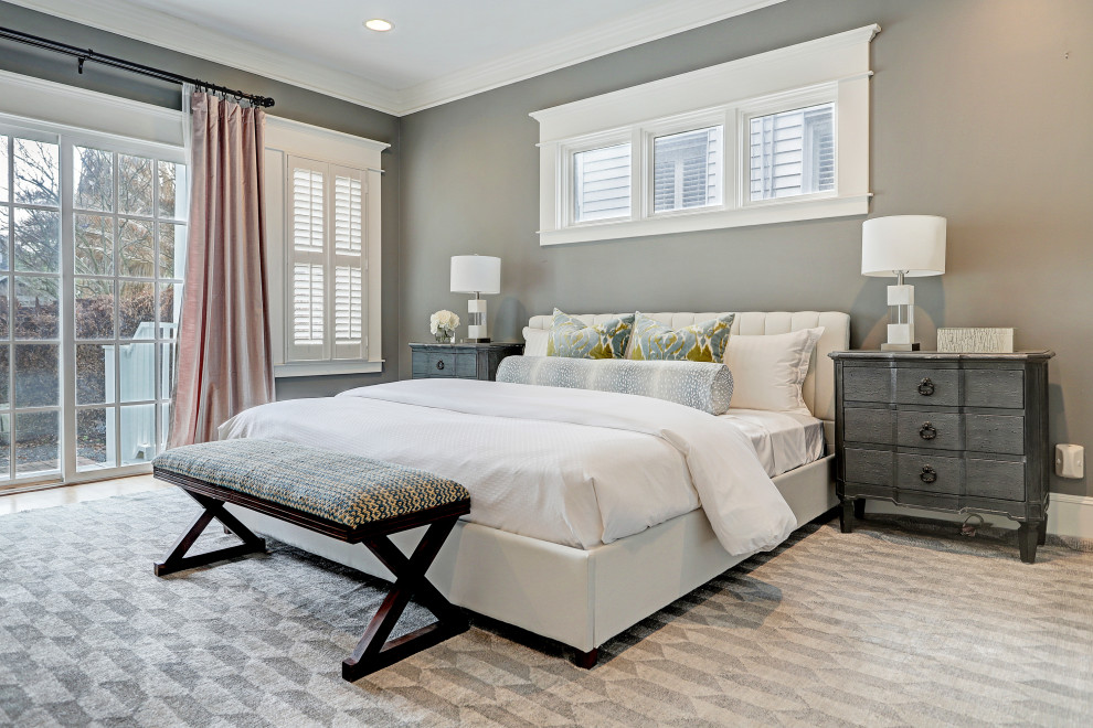 Photo of a large transitional master bedroom in Houston with grey walls, medium hardwood floors and brown floor.