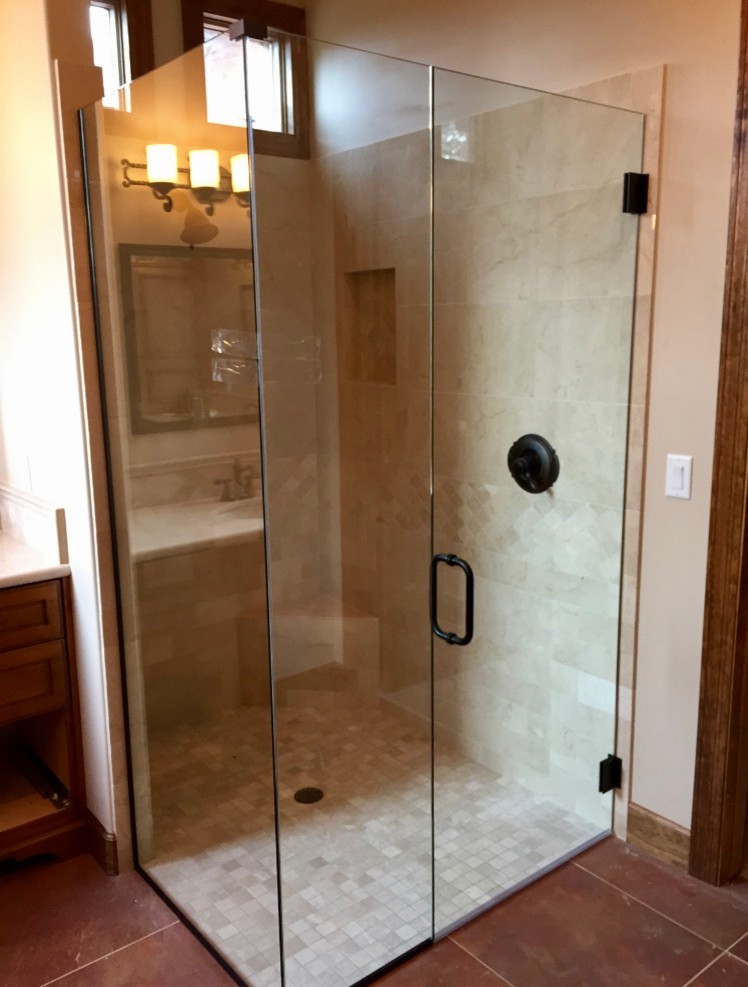 Photo of a mid-sized transitional master bathroom in Phoenix with recessed-panel cabinets, medium wood cabinets, a corner shower, beige tile, ceramic tile, ceramic floors, red floor, a hinged shower door and beige walls.