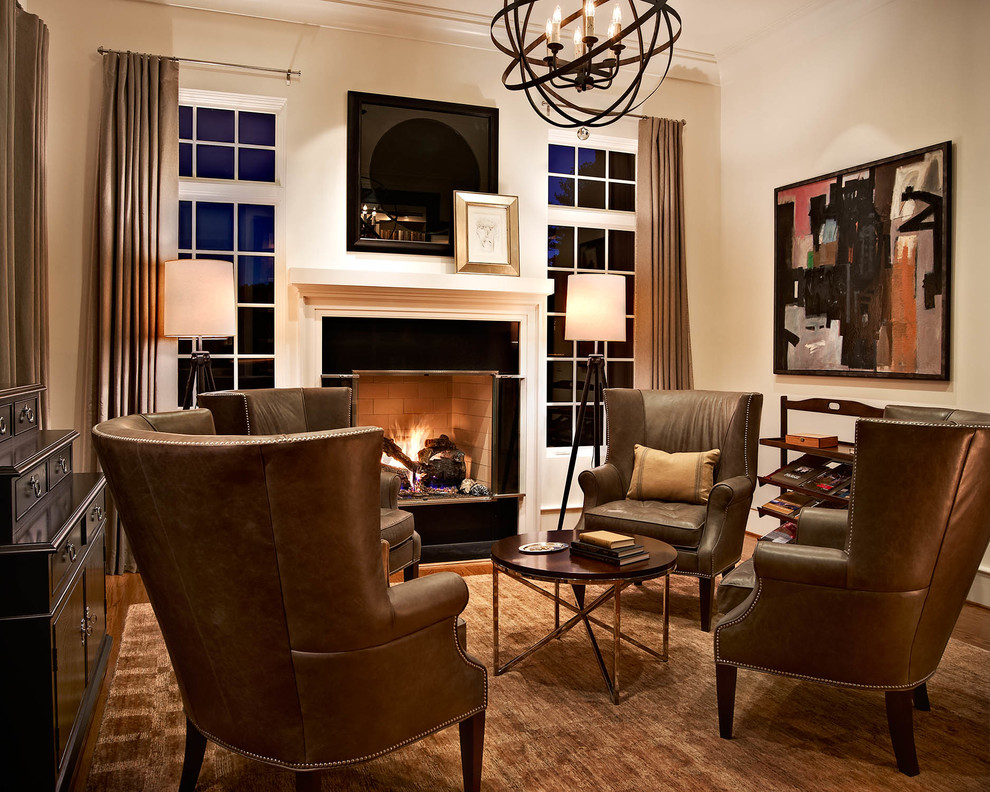 Inspiration for a transitional living room in Raleigh with beige walls, medium hardwood floors and a standard fireplace.