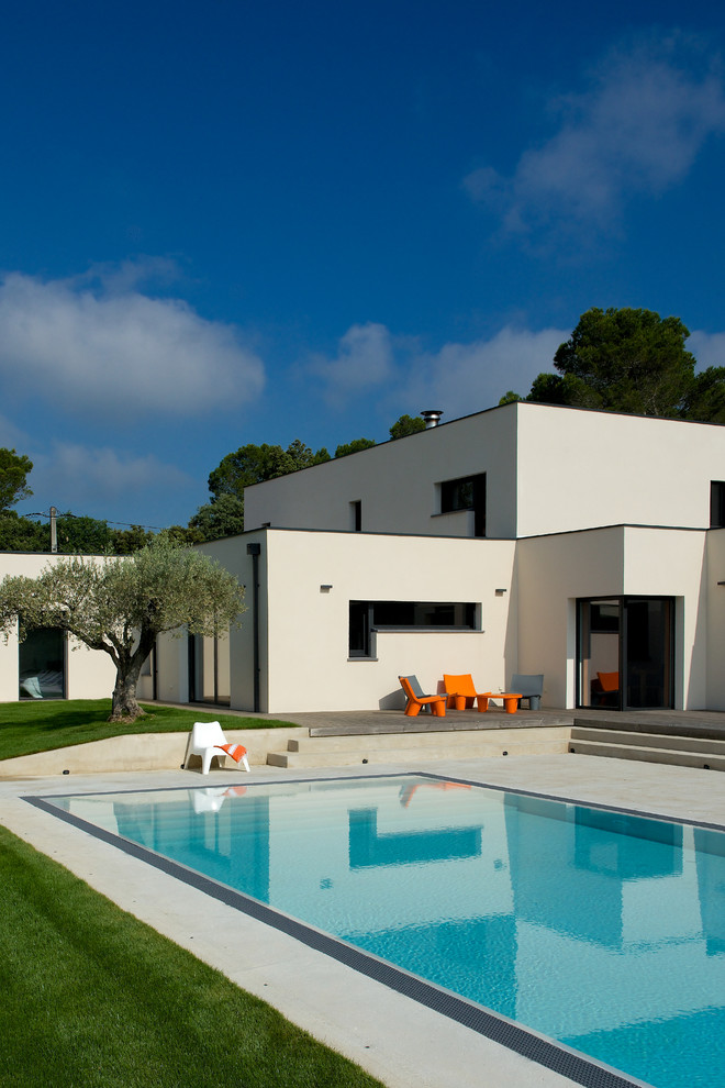 Photo of a contemporary front yard rectangular pool in Marseille with concrete slab.