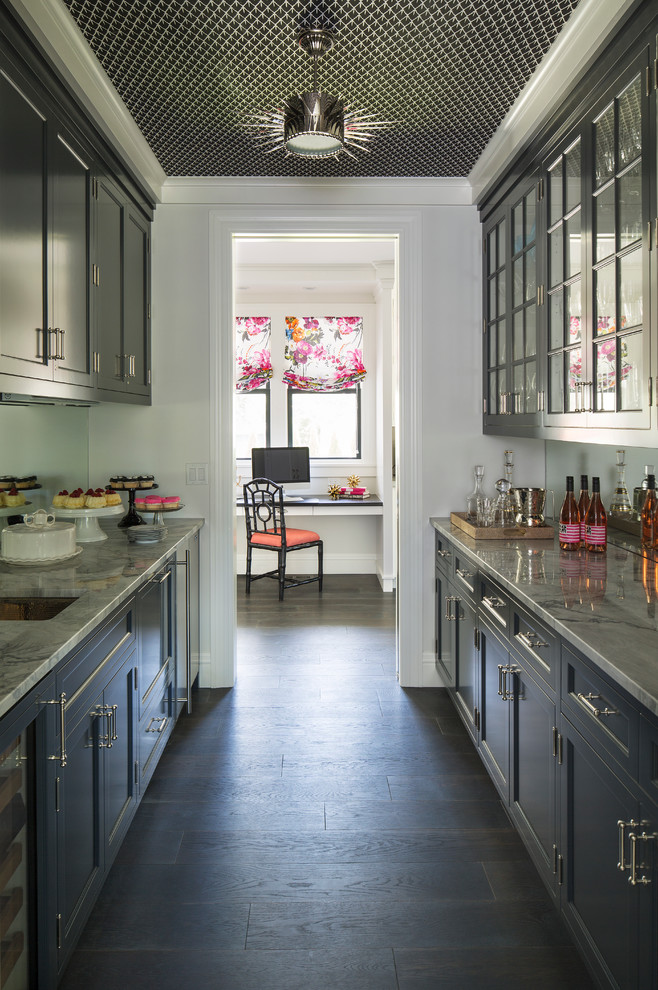 Photo of a transitional kitchen pantry in Minneapolis with white cabinets, grey splashback, stainless steel appliances, dark hardwood floors and with island.