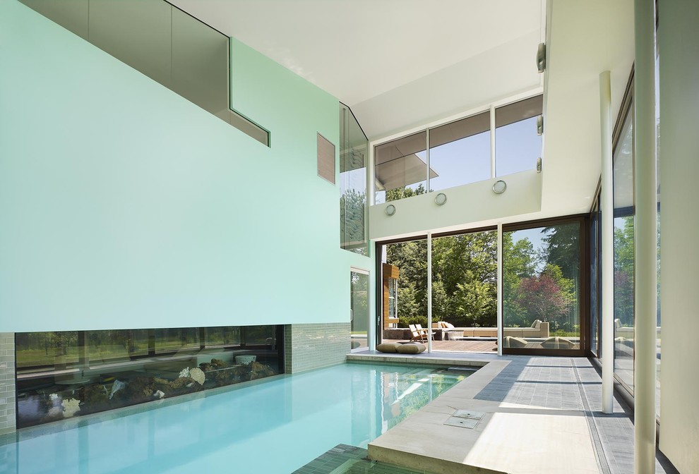 Design ideas for an expansive modern indoor rectangular lap pool in Toronto with natural stone pavers.