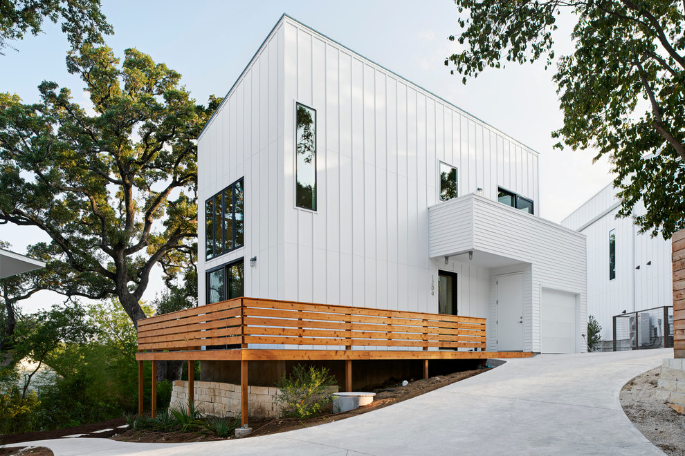 Design ideas for a small modern two-storey white exterior in Austin with concrete fiberboard siding.
