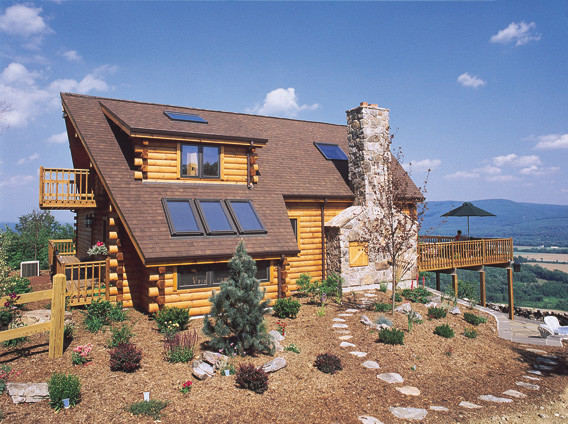 Photo of a mid-sized country two-storey brown exterior in Denver with wood siding and a gable roof.