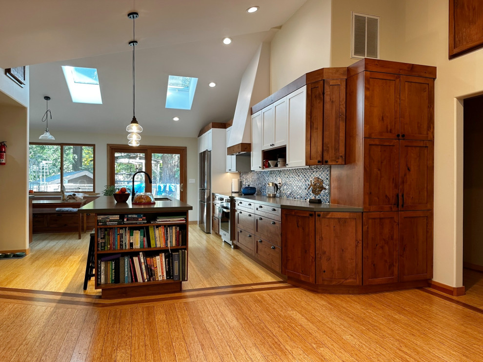 Foto de cocina comedor lineal de estilo americano de tamaño medio con fregadero bajoencimera, puertas de armario de madera oscura, encimera de cuarzo compacto, salpicadero azul, salpicadero de azulejos de cerámica, electrodomésticos de acero inoxidable, suelo de madera clara, una isla, suelo amarillo y encimeras grises