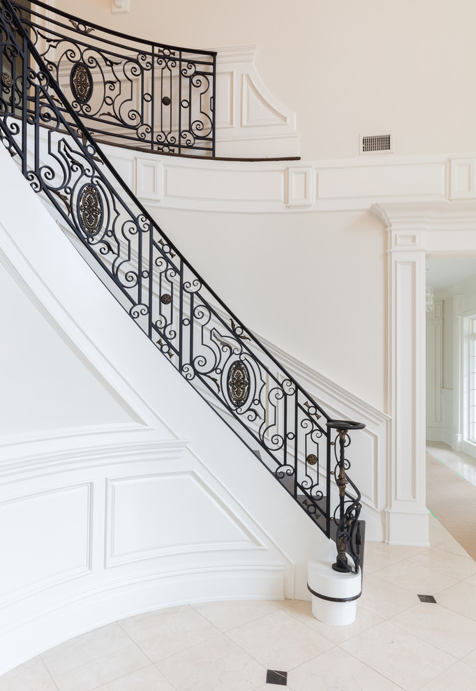 Inspiration for a large mediterranean wood curved staircase in New York with metal railing.