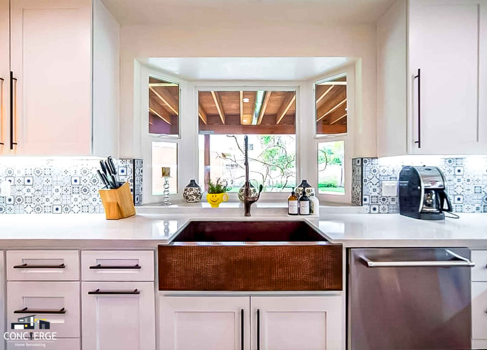 Design ideas for a medium sized contemporary u-shaped open plan kitchen in Los Angeles with shaker cabinets, white cabinets, blue splashback, ceramic splashback, coloured appliances and a breakfast bar.
