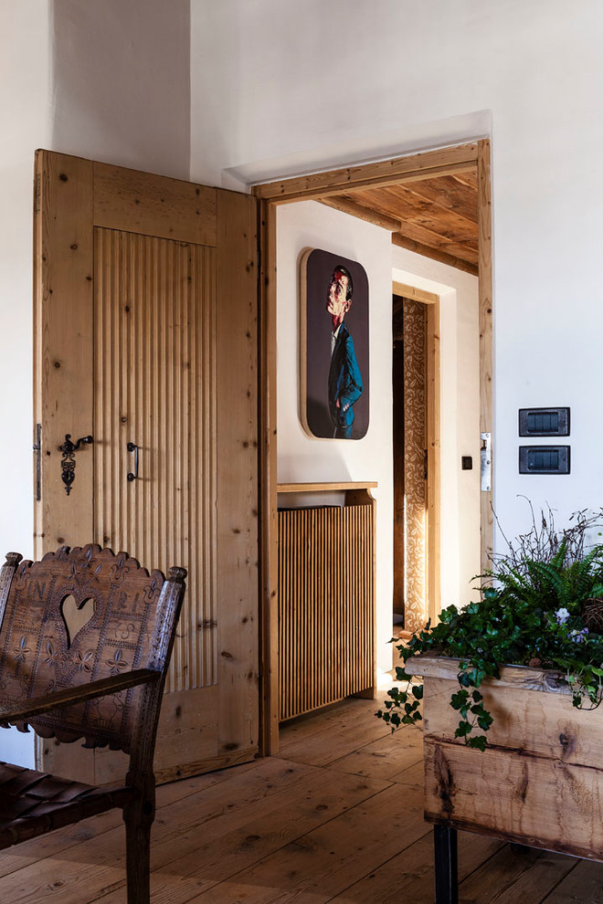 Inspiration for a mid-sized country entryway in Other with white walls.