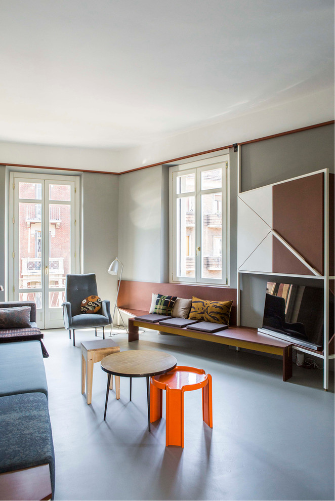 This is an example of a mid-sized midcentury enclosed family room in Turin with grey walls.