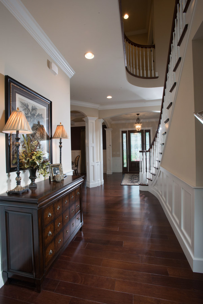 Large arts and crafts hallway in Other with beige walls and dark hardwood floors.